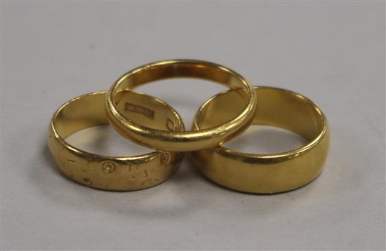 Three 22ct gold bands.